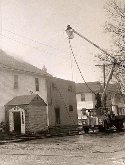 Ed Doiron in P.W. bucket truck, pressed into service on School Street (Photo by Stuart Langer)