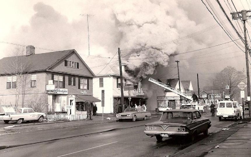 Deputy Chief's 1961 Ford can been seen in the driveway of Headquarters. Notice several other cars when on-street parking was permitted on Whitney Avenue in those days. (Photo by John Mongillo, Jr.)